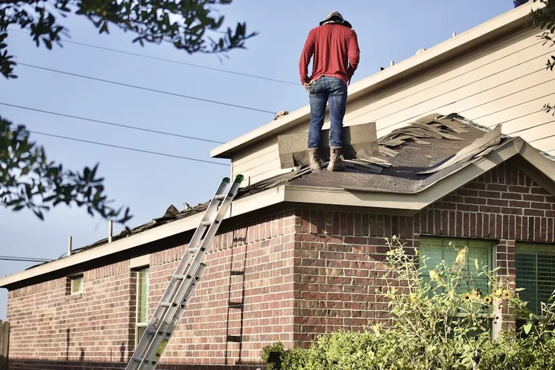 Professional roofer working on a residential roof in Old Tappan